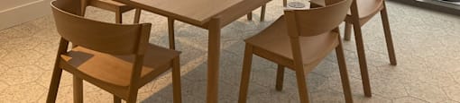 A conference room with a long table and chairs.
