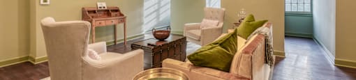 a living room with couches and chairs and a television