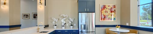 Now leasing senior 1-bedrooms in Baltimore, MD. A kitchen with a marble countertop and a breakfast bar.