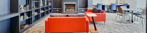 Now leasing senior 1-bedrooms in Baltimore, MD. A living room with a fireplace and a bookshelf.