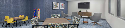 A conference room with a long table surrounded by chairs.