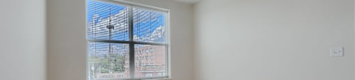 A room with a window and a ceiling fan.
