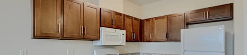 A kitchen with granite countertops and white appliances.