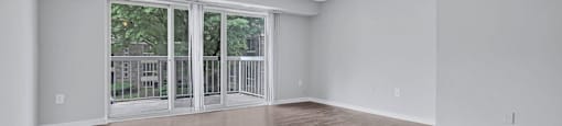 an empty living room with white walls and a window