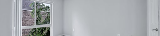 a empty room with a window and a tile floor