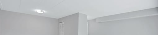 the living room of an empty home with white walls and carpet