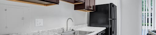 a kitchen with wood cabinets and a sink