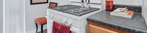 a kitchen with a stove top oven and a sink