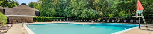 a swimming pool with trees in the background