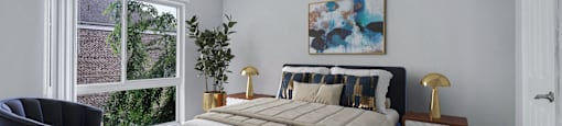 a bedroom with a bed and a large window