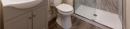 A white toilet sits next to a sink in a bathroom.