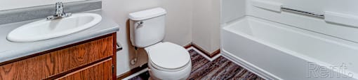 A bathroom with a toilet, sink, and bathtub.