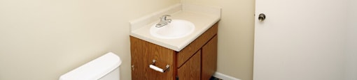 a bathroom with a sink toilet and mirror