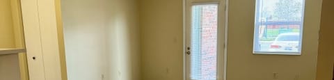 an empty living room with a hard wood floor