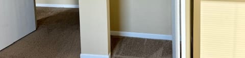 an empty closet with a door open