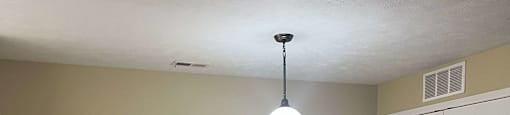 an empty living room with wood floors and a white door