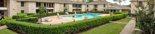 the view of a swimming pool with apartments in the background