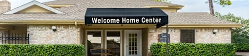 the entrance to the welcome home center in a brick building