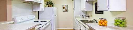 a kitchen with white appliances and white cabinets