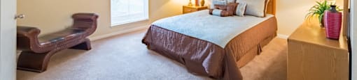 a bedroom with a bed and a ceiling fan