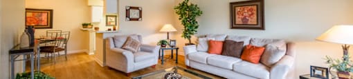 the living room of a house with a couch and chairs