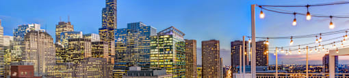 a view of the city skyline from a rooftop terrace