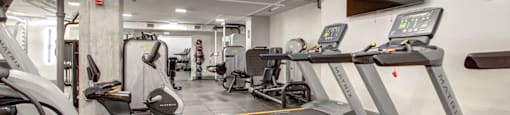 a gym with treadmills and other cardio equipment in a building
