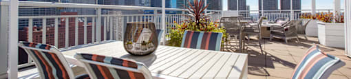 a deck with a table and chairs and a view of the city