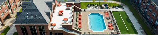 Luxury apartments with multi-level fitness center, outdoor entertainment lounge with grilling stations, luxury swimming pool, poolside lounges, and manicured gardens at Luxembourg Apartments