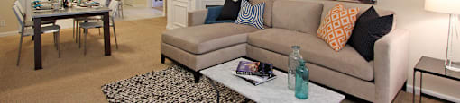 Spacious apartment in central Omaha with condo-style layout, white kitchen cabinets, kitchen island, and built-in shelves at Embassy Park Apartments