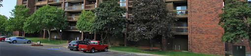 Apartments in central Omaha with brick exteriors, huge balconies, spacious balconies, scenic views, lots of trees, and beautiful landscaping at Embassy Park Apartments in Omaha, Nebraska