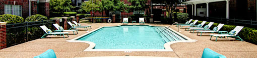 Luxury swimming pool with relaxing sundeck at Tuscany Apartments in Houston.
