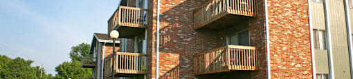 Apartments in La Vista with brick exteriors, park-like setting, scenic views, and lots of trees at The Inverness Apartments