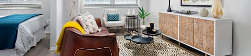 a living room with a couch and a chair and a bed