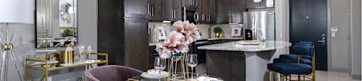 Spacious luxury apartments with porcelain tile floors, dark wood cabinets, and granite countertops at Xenia Apartments in Golden Valley, Minnesota