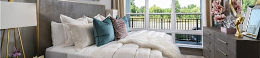 Luxury apartments with master bedroom to fit a king size bed, attached master bathroom and walk-in closet at Xenia Apartments in Golden Valley, Minnesota