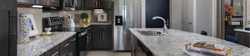 Luxury apartments with spacious floor plan, granite countertops, stainless steel appliances, built-in wine rack, kitchen island, and porcelain tile floor at Xenia Apartments in Golden Valley, Minnesota