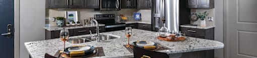 Luxury apartments with granite countertops, stainless steel appliances, built-in wine rack, kitchen island, and porcelain tile floor at Xenia Apartments in Golden Valley, Minnesota