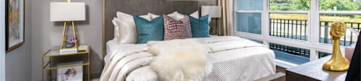 Luxury bedroom with walk-in closet and scenic views at Xenia Apartments in Golden Valley, Minnesota