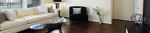 Luxury apartments in Houston with spacious open floor plan with oversized windows, lots of natural light, and hardwood floors.