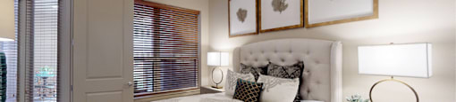 Luxury apartments with spacious master bedroom to accommodate a king-size bed and dresser with walk-in closet and master bathroom at Tuscany Walk Apartments in Houston Texas.