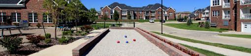 Luxury apartments with swimming pool, poolside lounges, grilling station, ping-pong table, and bocce ball court, and brick exteriors at Bellemeade Apartments in west Des Moines