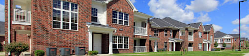 Luxury townhomes with attached garages and red brick exteriors at Bellemeade Apartments in west Des Moines