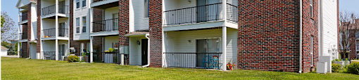 Apartments with red brick exteriors and large balconies at The Vanderbilt Apartments in Omaha, Nebraska