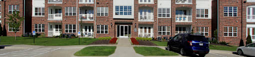 Luxury apartments in a gated community with brick exteriors and underground parking garage at Bellemeade Apartments in west Des Moines