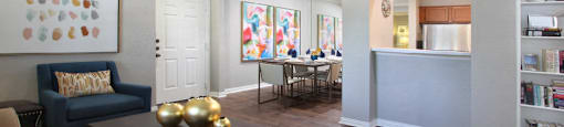 Luxury apartments with wood grain plank floors, built-in shelves, and spacious dining room with mirror accent wall at Lenox Village Apartments in Lincoln, Nebraska