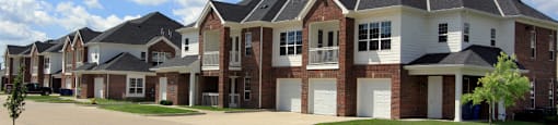 Luxury townhomes with attached garages and red brick exteriors at Bellemeade Apartments in west Des Moines