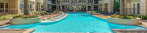 Luxury apartments with resort-style pool and palm trees, fountains, lap lane, and pool-side lounge chairs
