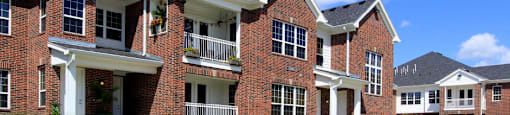 Luxury townhomes with attached garages and red brick exteriors at Bellemeade Apartments in west Des Moines