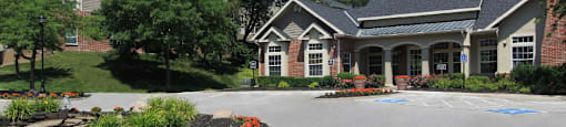 a large house with a driveway and a parking lot